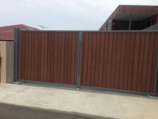 Automatic swinging driveway gates timber in steel frame Sydney